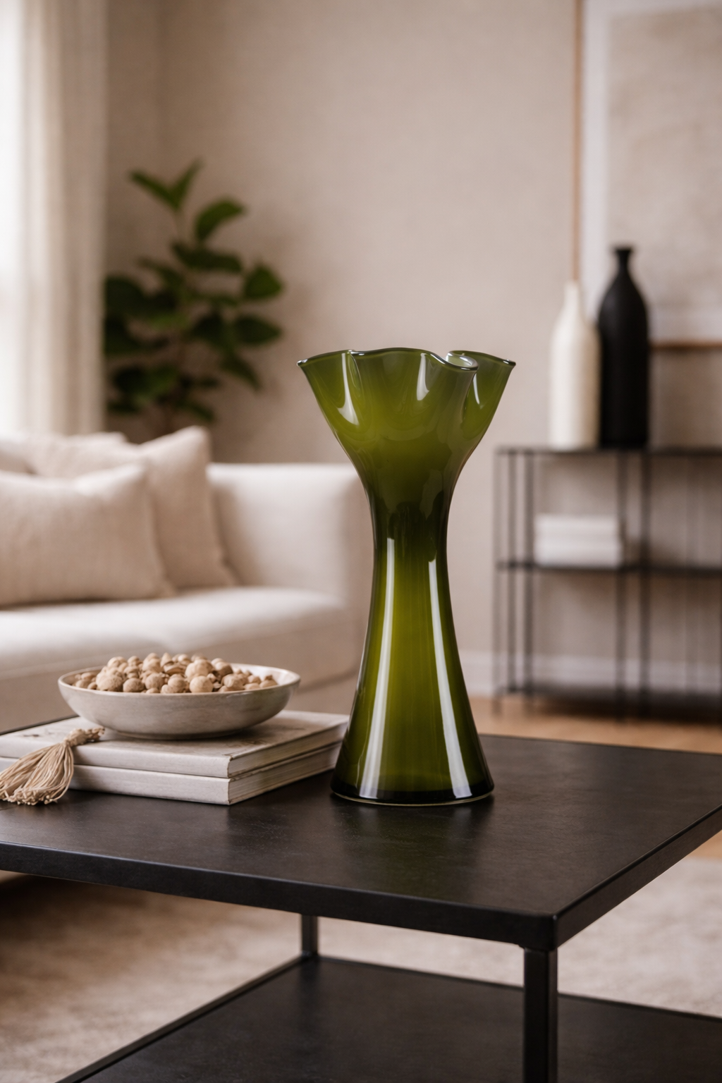 Green vase on a coffee table in a living room setting