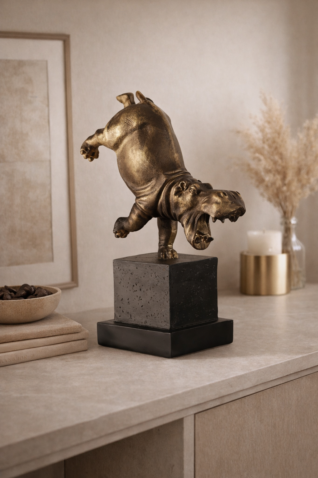 Bronze sculpture of a bear on a pedestal in a home decor setting