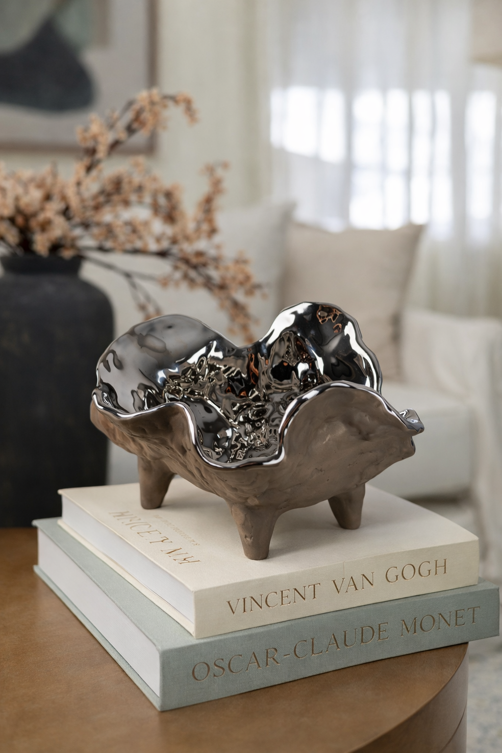 Decorative sculpture on top of books with a blurred indoor setting