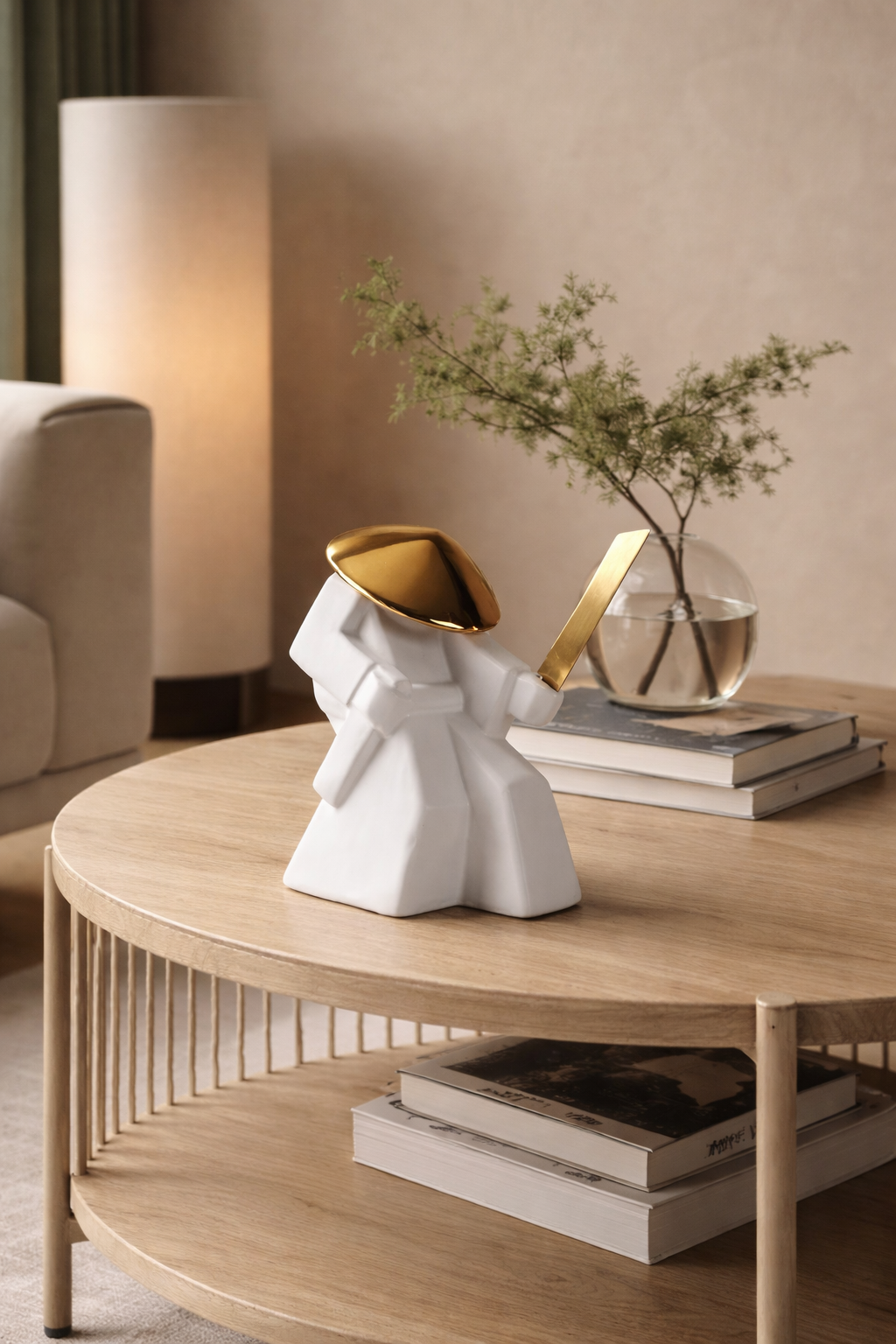 Round wooden coffee table with decorative items in a living room setting