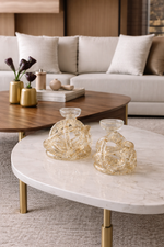 Living room with a beige sofa, wooden coffee table, and decorative items.
