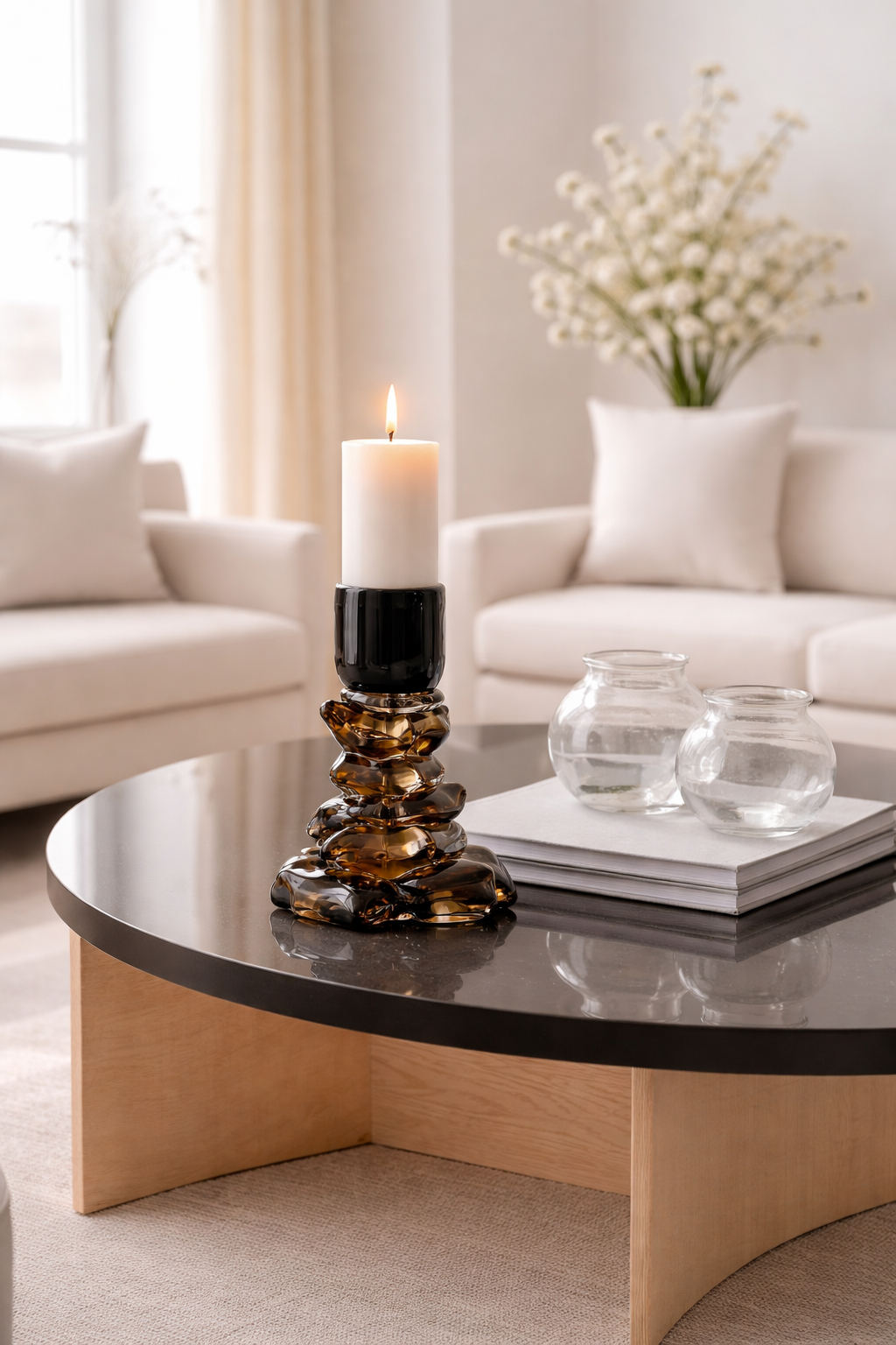 Modern living room with a coffee table featuring a candle and decorative items.