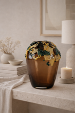 Decorative vase with artistic design on a table in a room setting