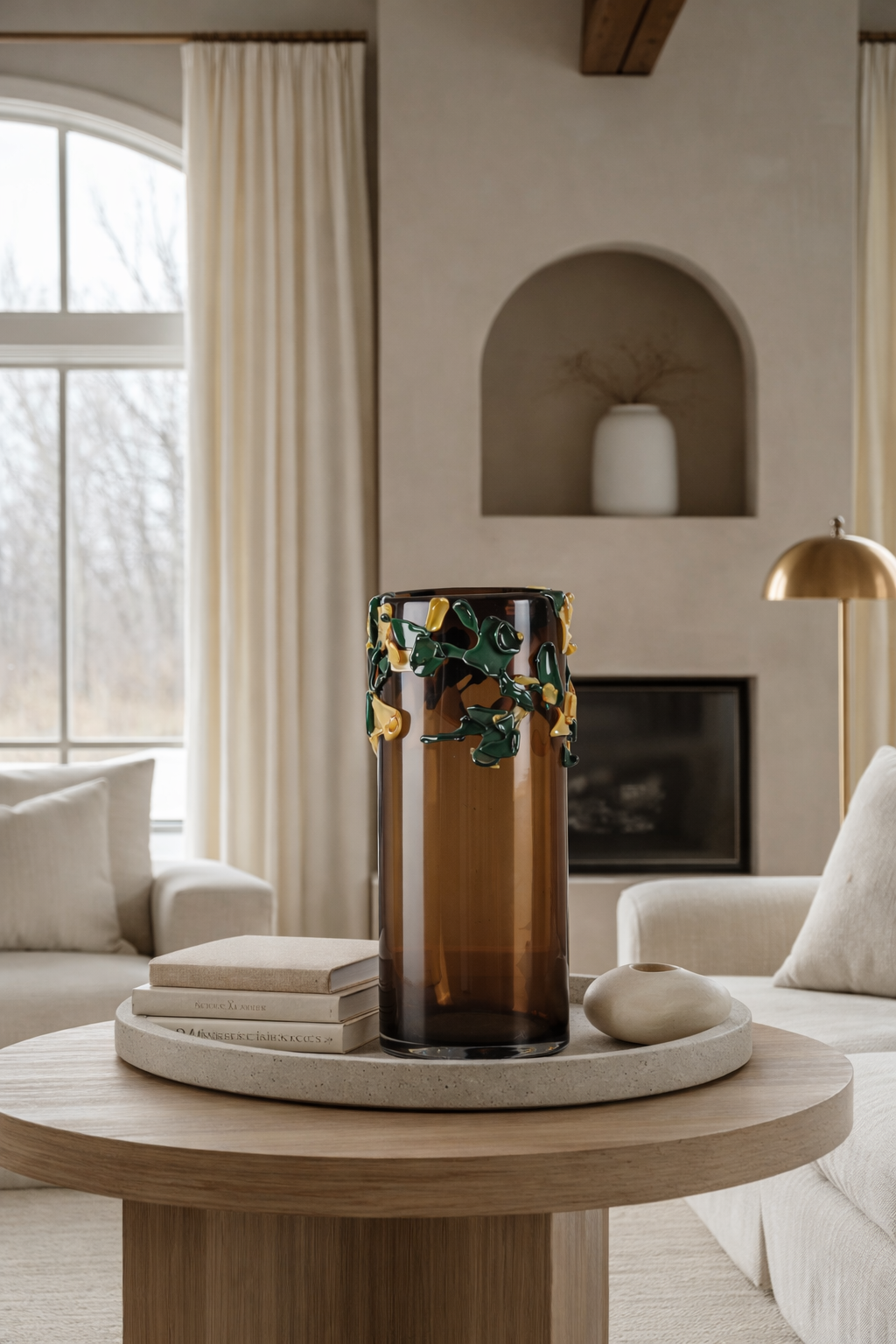 Living room with a round wooden coffee table featuring a decorative vase and candles.