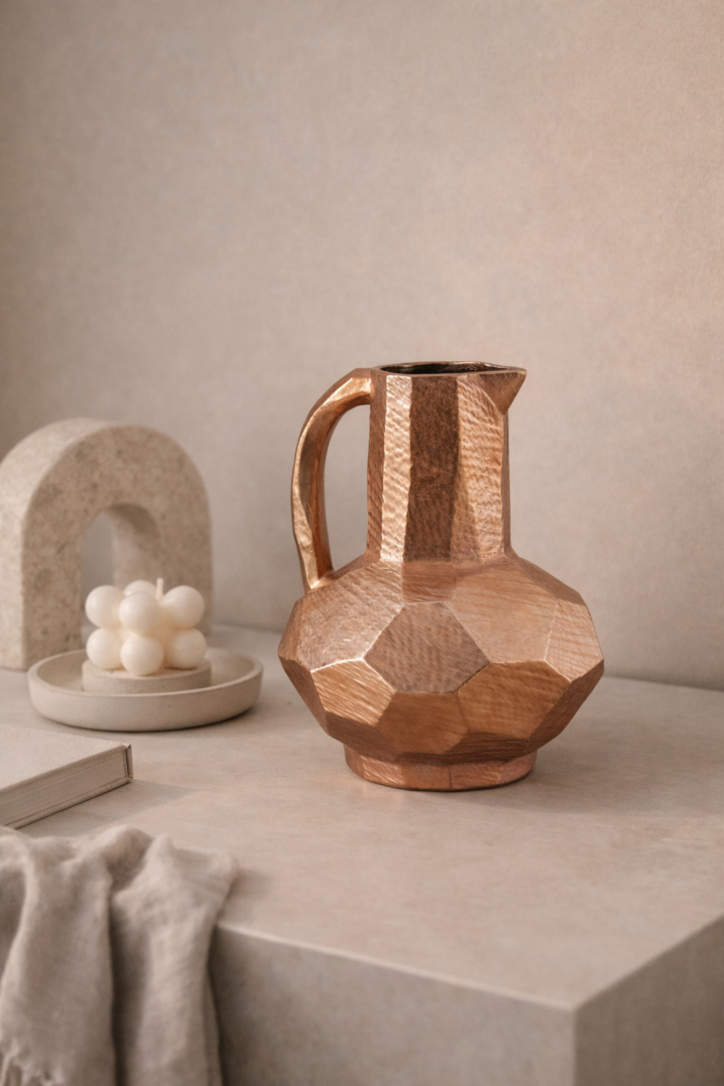 Wooden geometric pitcher on a neutral surface with a soft background