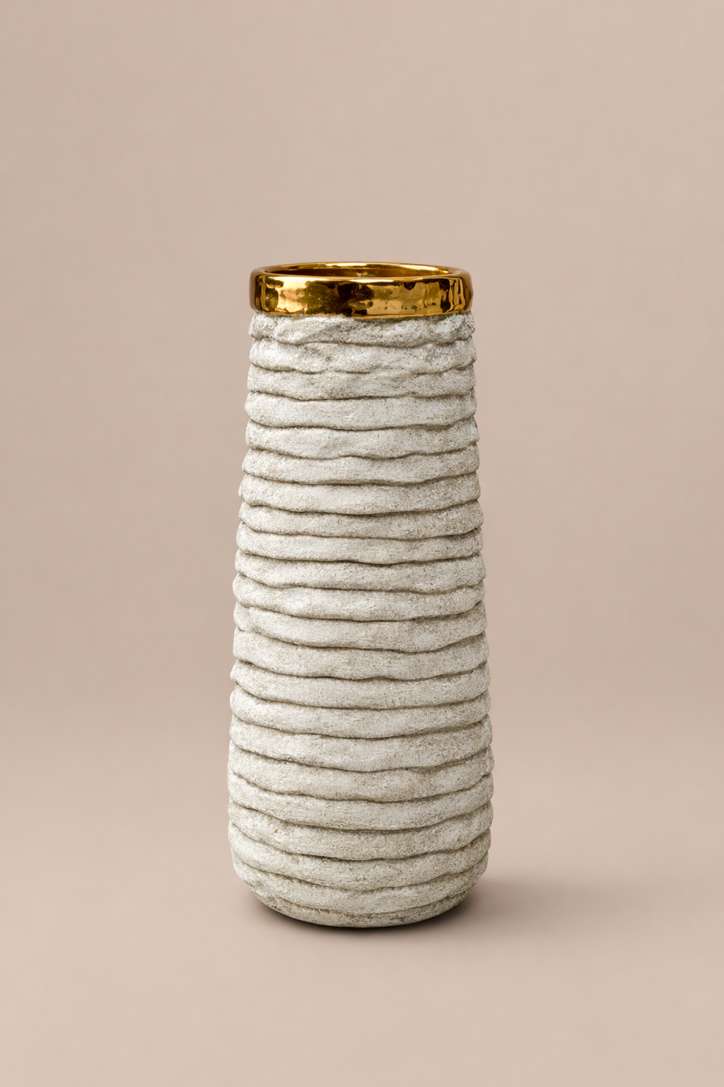 Textured vase with gold rim on a beige background
