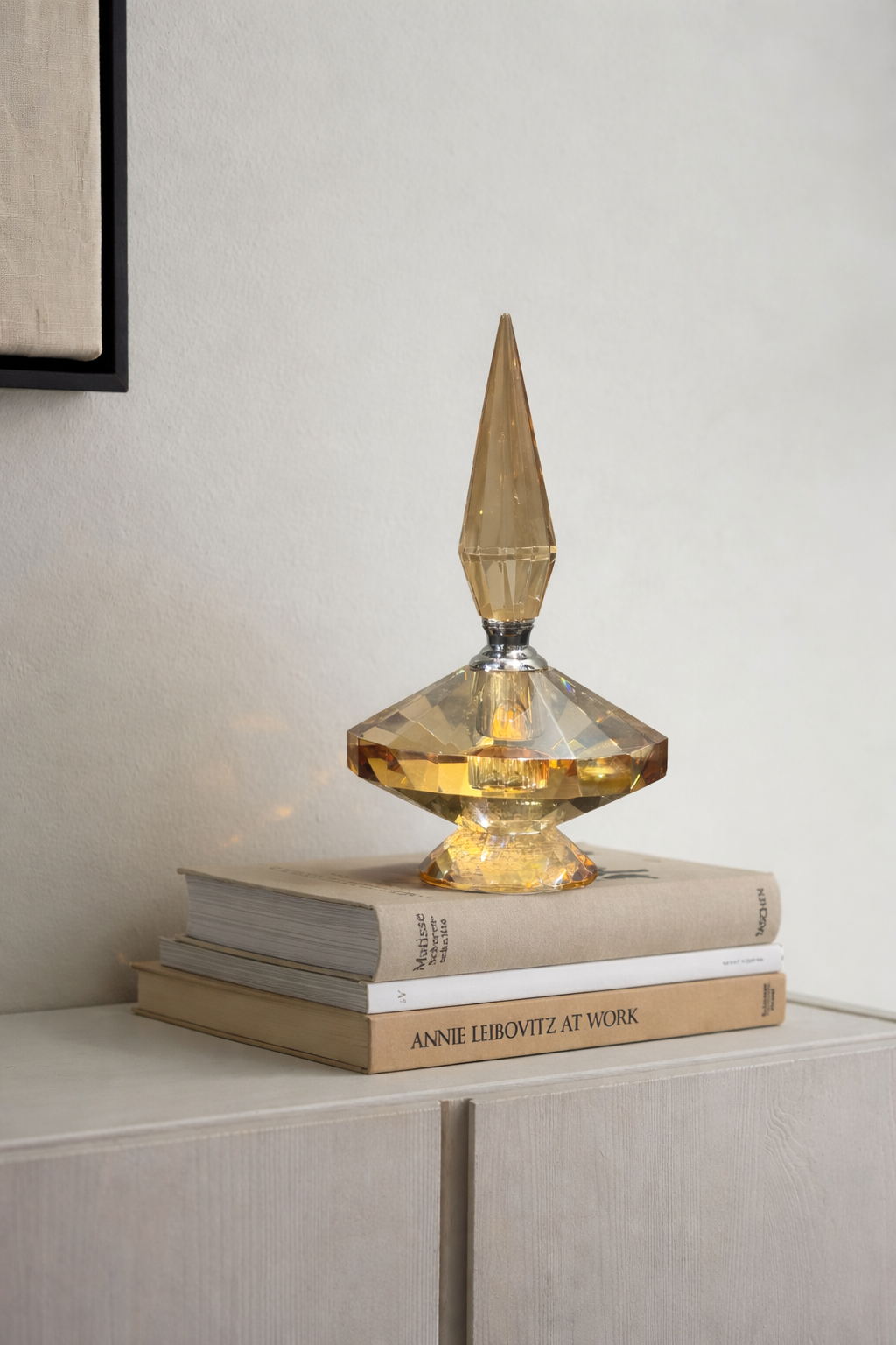 Decorative glass object on top of books with a neutral background