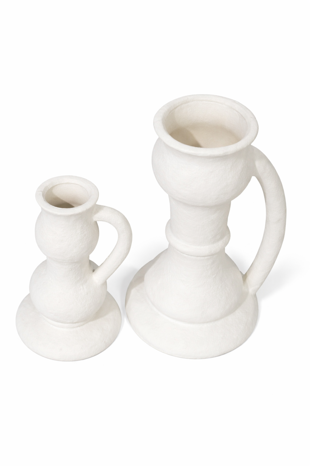Two white ceramic candle holders on a white background