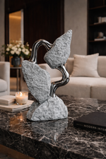 Decorative stone sculpture on a marble surface with a modern interior setting.