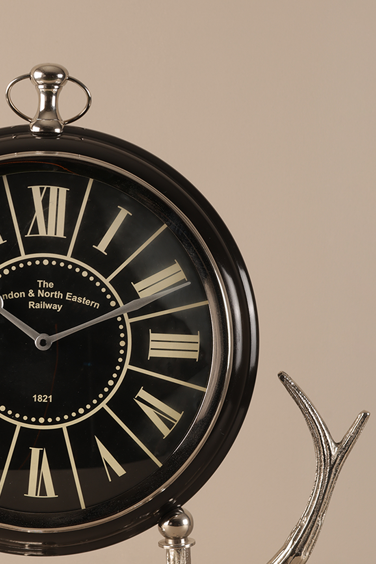 Vintage-style clock with Roman numerals on a beige background