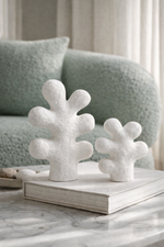 Decorative coral-like sculptures on a book with a blurred background