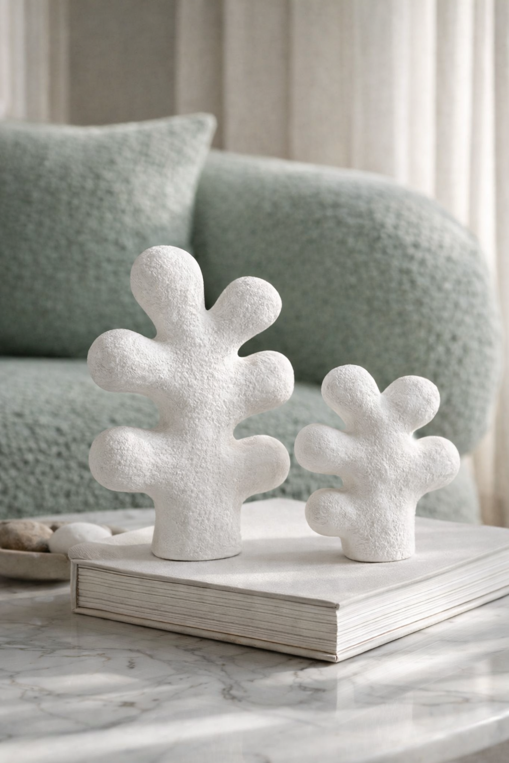 Decorative coral-like sculptures on a book with a blurred background