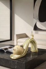 Decorative sculpture on a black surface with a modern interior background