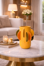 Yellow cactus-shaped vase on a marble table in a living room setting