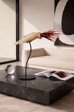 Decorative squid lamp on a marble coffee table with a modern interior setting.