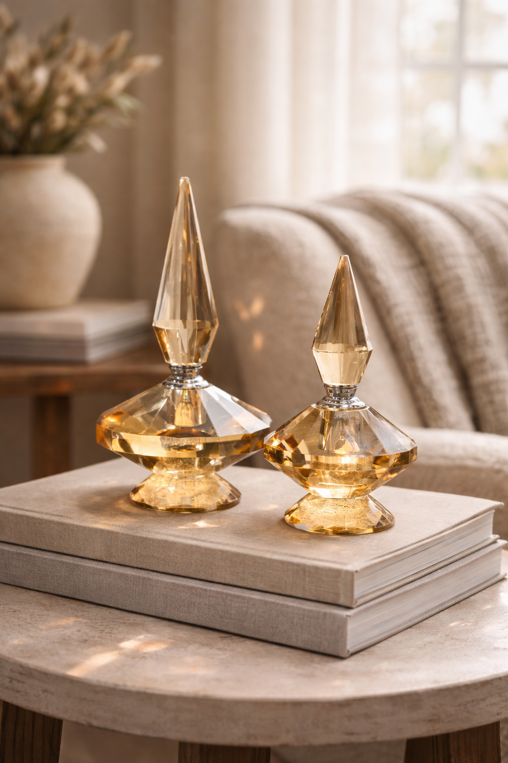 Two gold decorative items on books with a blurred indoor background