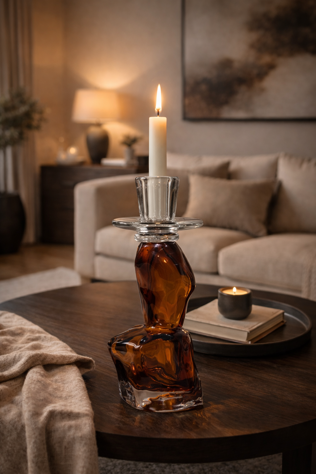 Candle holder with a candle on a wooden table in a cozy living room.