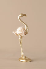 Elegant gold flamingo sculpture with blush pink feathers displayed as luxury home decor