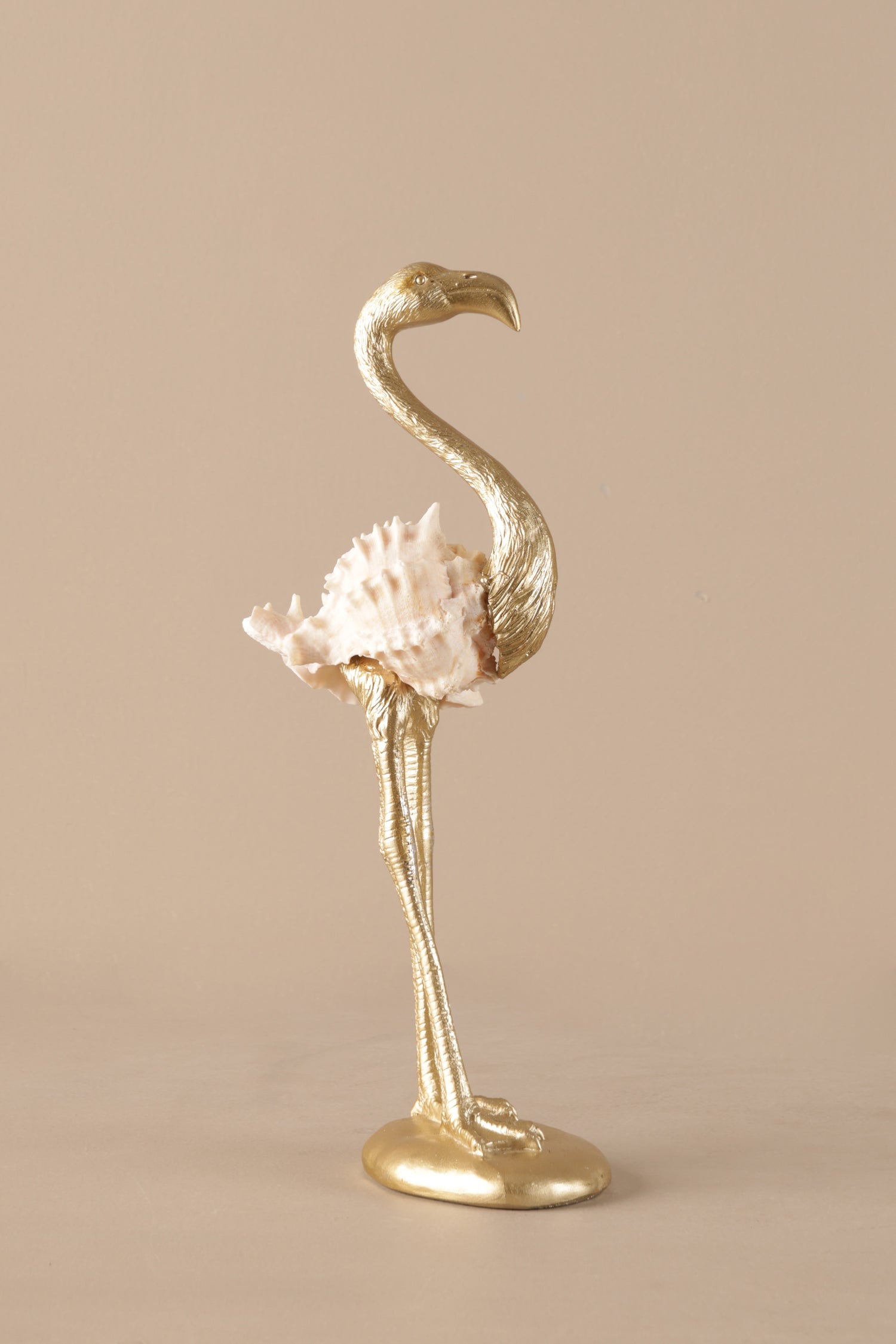 Elegant gold flamingo sculpture with blush pink feathers displayed as luxury home decor
