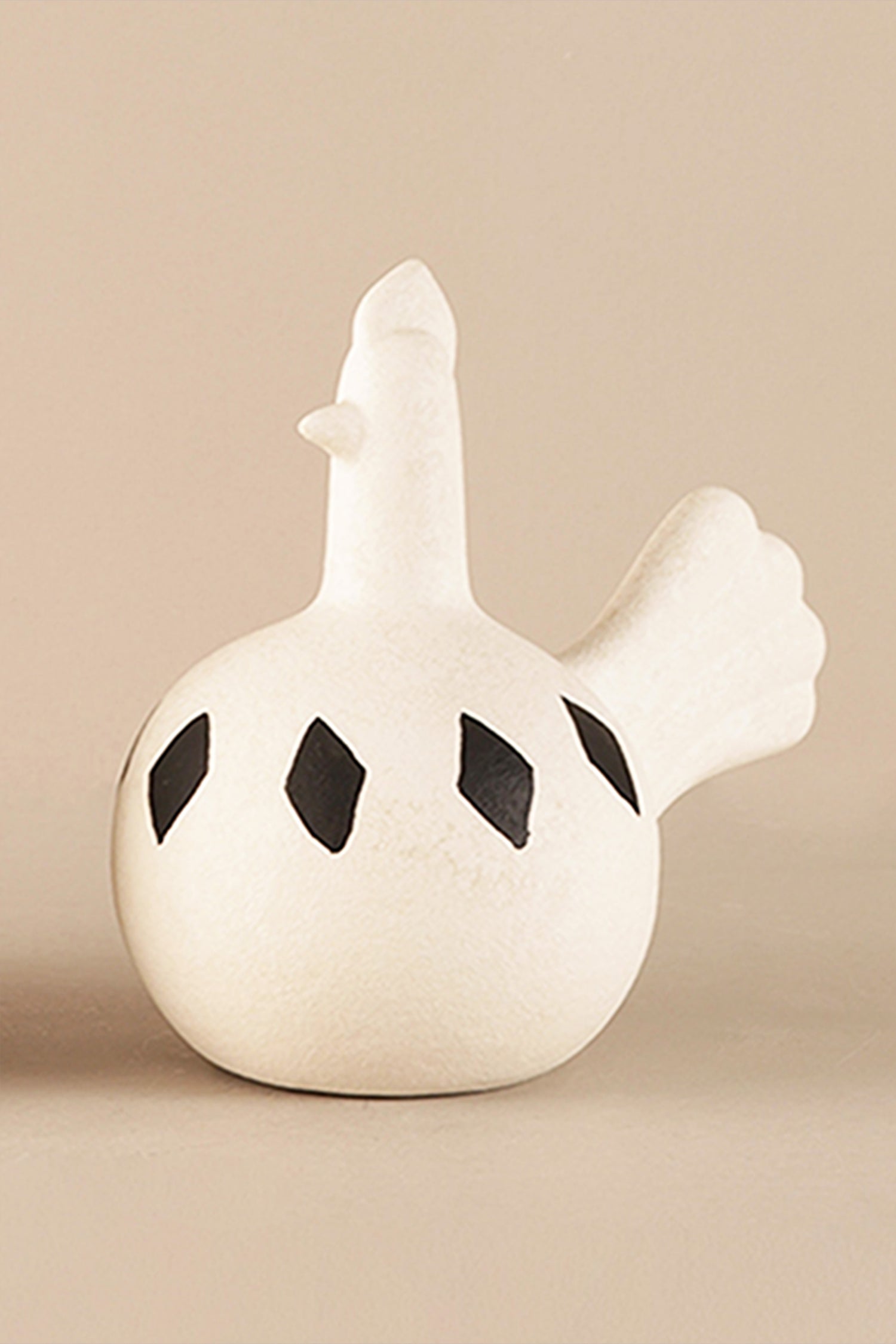 Minimalist ceramic bird vase showing matte texture and black diamond motifs

