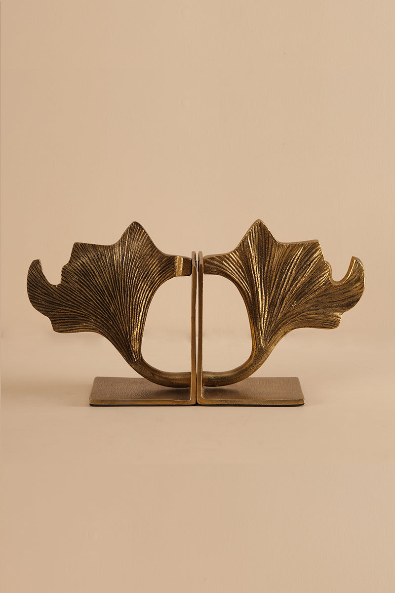 Ginco Gynco brass bookend featuring an artistic leaf form with antique brass finish