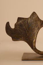 Close-up of Ginco Gynco brass bookend highlighting textured metal finish