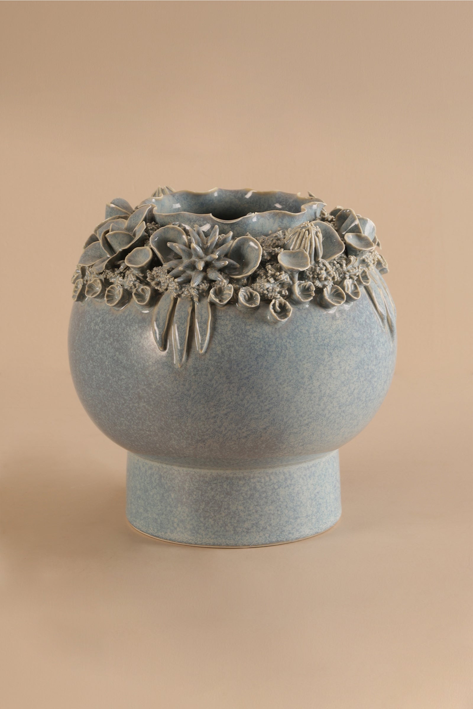 Decorative ceramic vase with floral patterns on a beige background