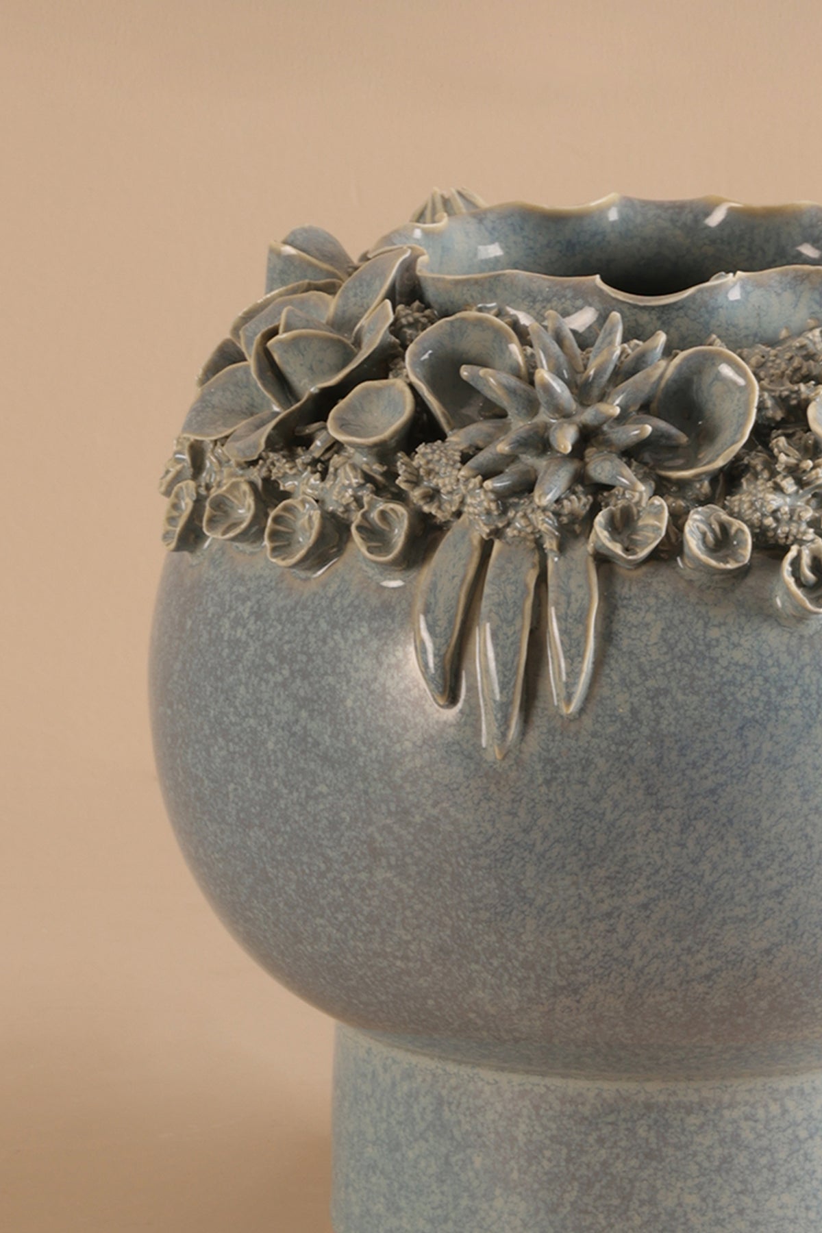 Decorative ceramic vase with floral patterns on a beige background
