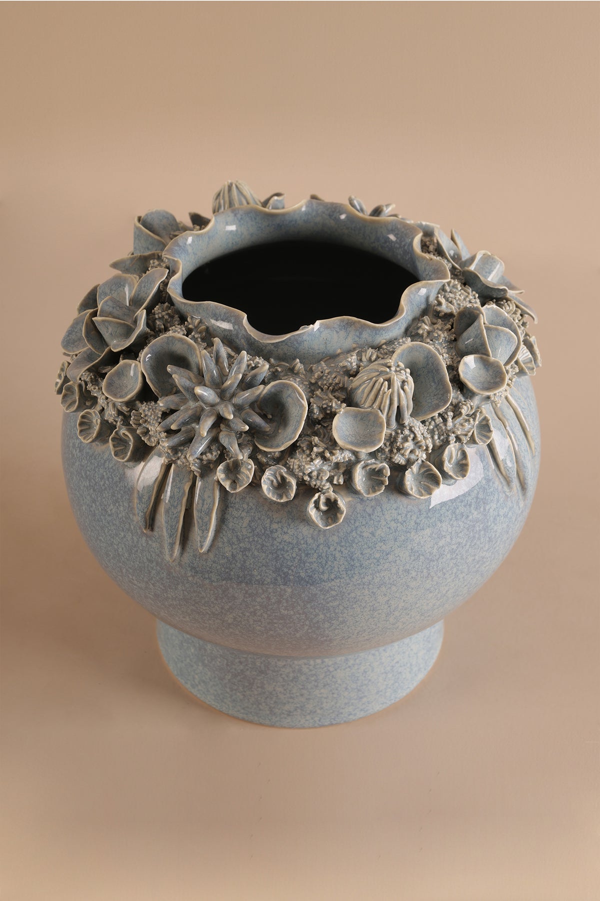 Decorative ceramic vase with floral patterns on a beige background