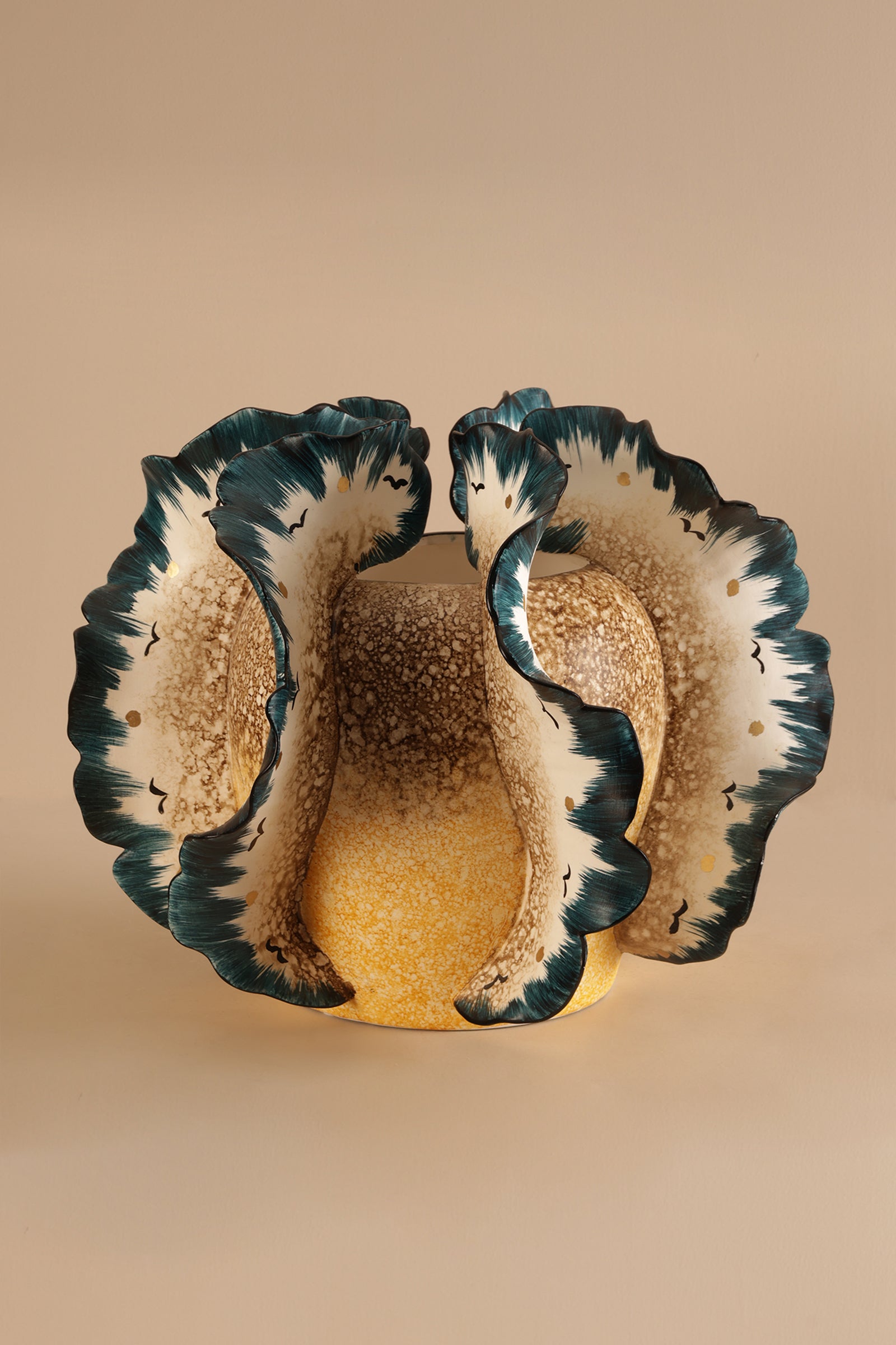 Ceramic shell-shaped bowl with scalloped edge on a beige background