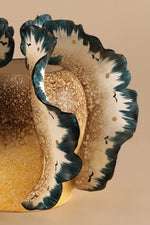 Decorative ceramic plate with a stylized animal design on a beige background