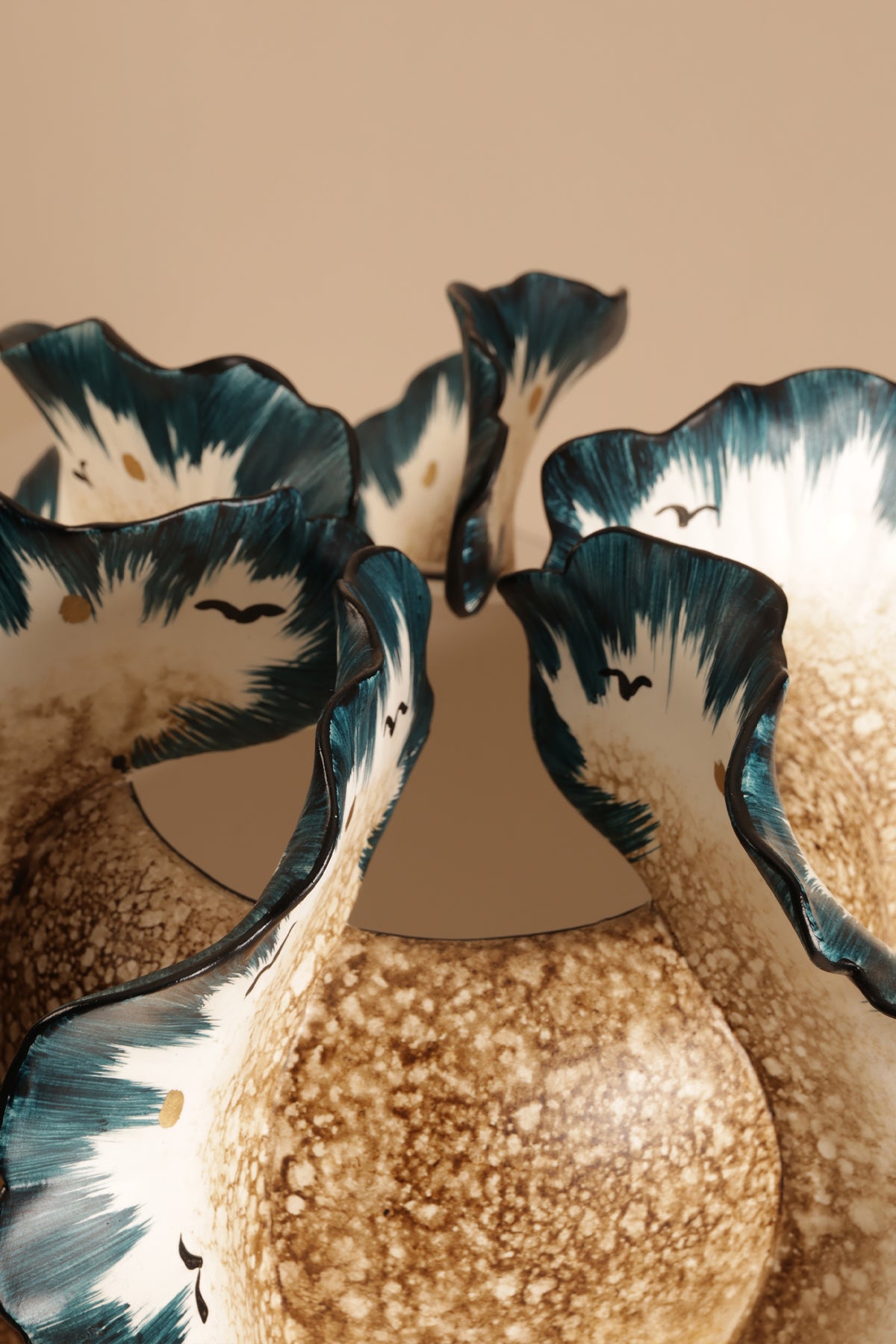 Decorative wall light fixture with floral design on a beige background