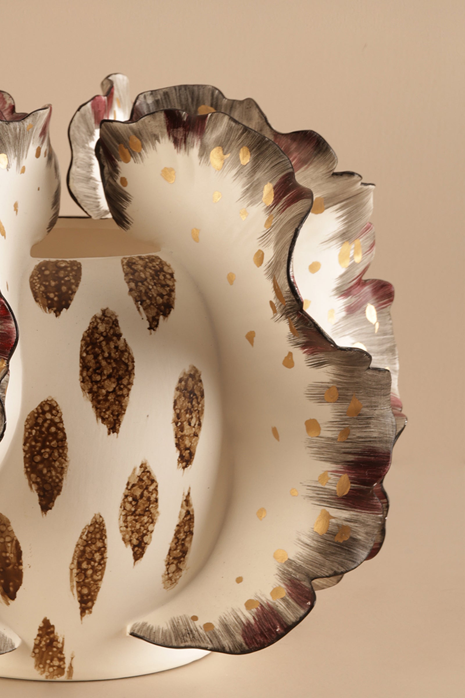 Decorative ceramic plate with leaf patterns on a beige background