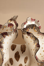 Decorative wall light fixture with wavy design and colorful pattern on a beige background
