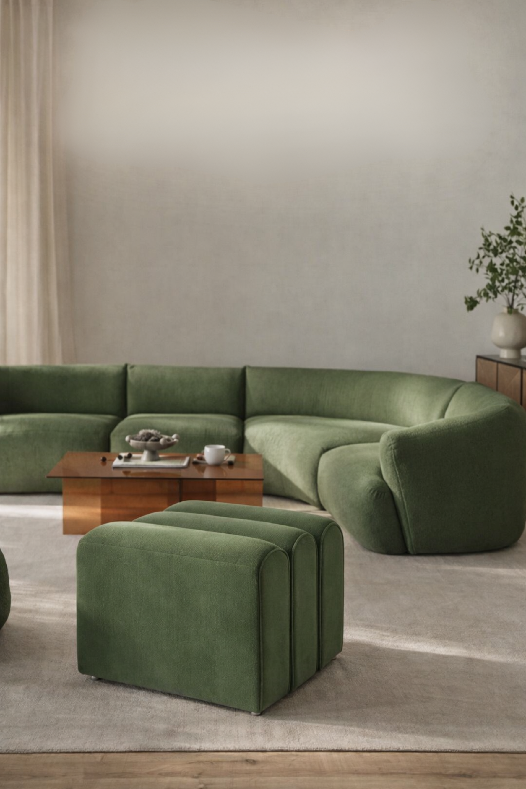 Modern living room with a green sectional sofa and matching ottoman.